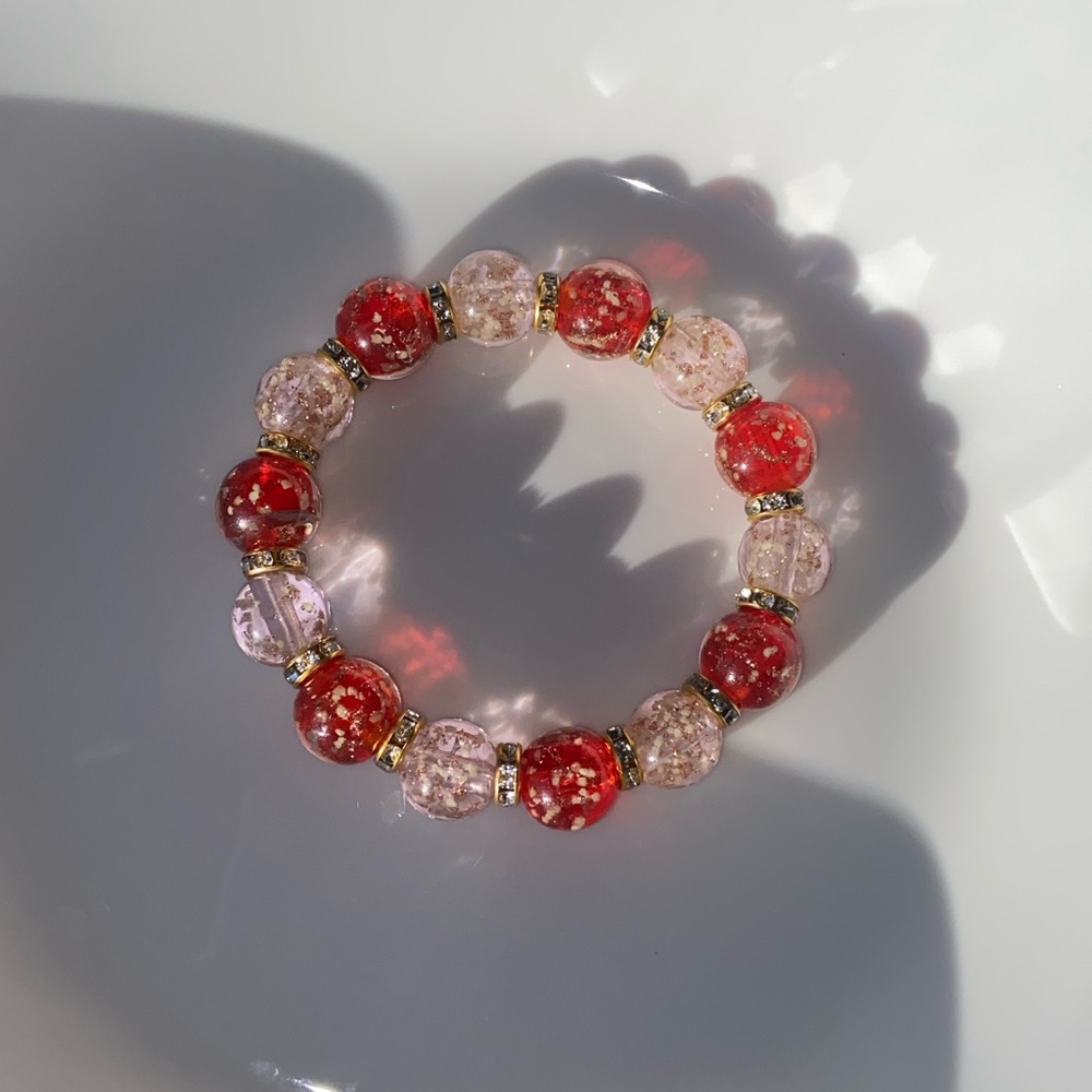 Beautiful pink and red glass beads bracelet with golden spacers